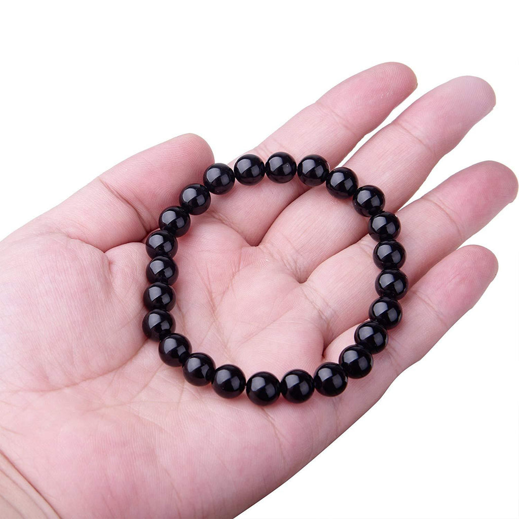 Bracelet en agate noire présenté sur un support clair