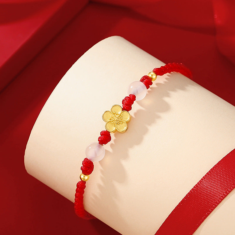 Bracelet Fleur de Pêcher, fleur sur cordon rouge porte-bonheur